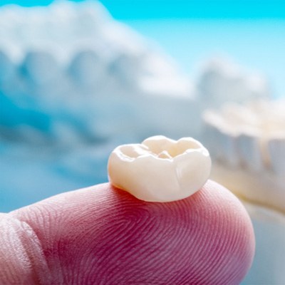 close up of a dental crown on a finger