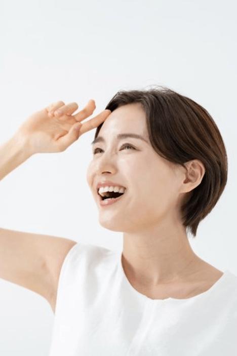 a woman smiling after getting her dental crown