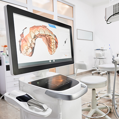 Digital dental impressions of a patient's teeth on computer screen in dental office