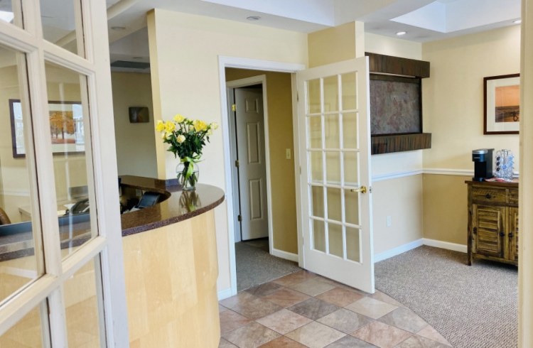 Dental treatment room with window and yellow walls