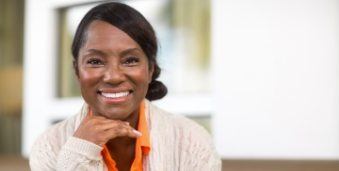 Smiling older woman in beige cardigan